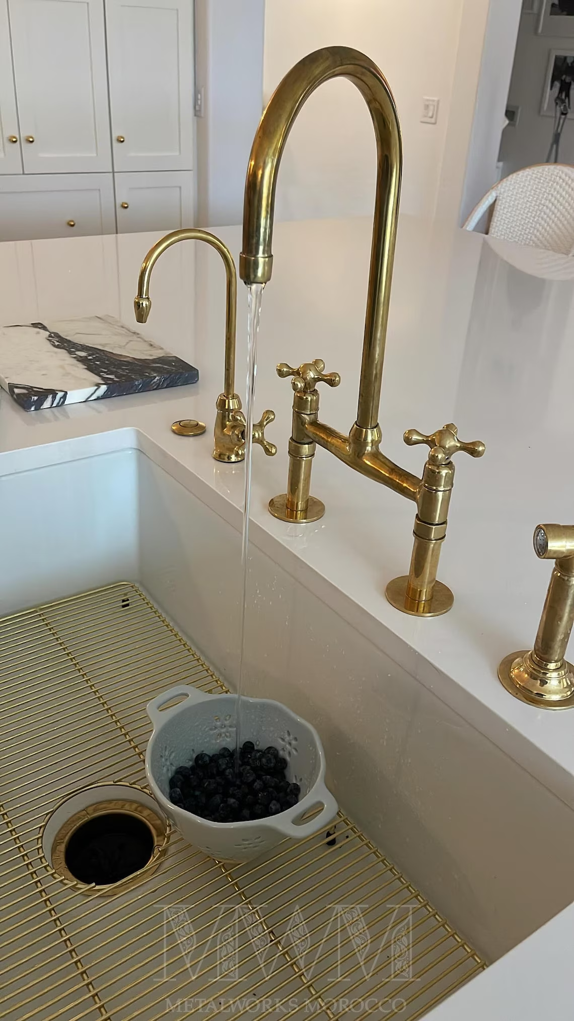 Aged brass gooseneck faucet over a farmhouse sink