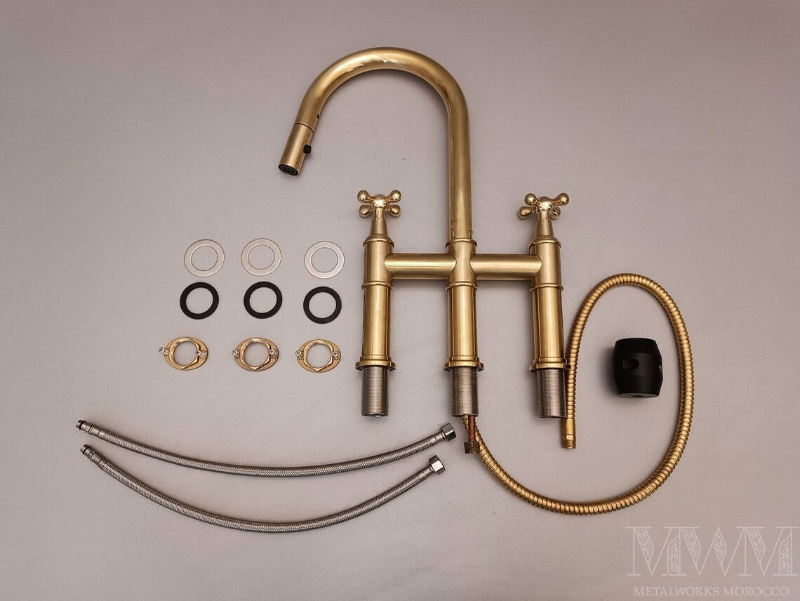 Unlacquered Brass Bridge Faucet With Pull Down Sprayer in styled kitchen setting
