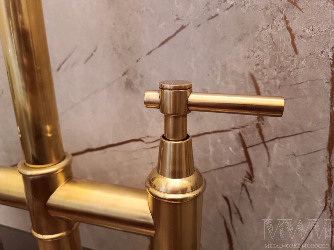 Unlacquered Brass Bridge Faucet With Pull Down Sprayer spout close-up showing curve and finish