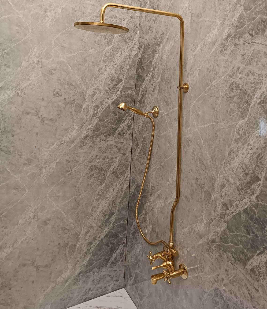 Solid Brass Bathtub And Exposed Shower Faucet Combo And Handheld unlacquered brass patina close-up