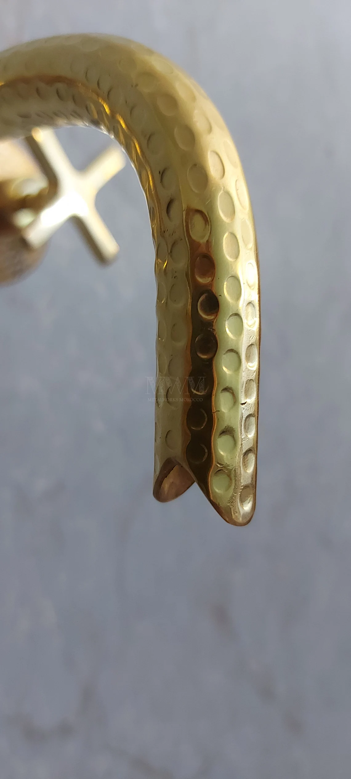 Brass Hammered Wall Mounted Bathroom Faucet With Curved Spout in styled room setting